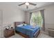 Bedroom with carpet floor features a wooden bed, end table and a window with custom curtains at 3304 Rockland Ridge Dr, Cary, NC 27519