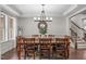 Elegant dining room features a large wooden table, decorative mirror, and stylish chandelier at 3304 Rockland Ridge Dr, Cary, NC 27519