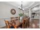 Elegant dining room featuring hardwood floors, chair railing, and large windows at 3304 Rockland Ridge Dr, Cary, NC 27519