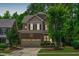 Attractive home exterior with a two-car garage, landscaped yard, and mature trees at 3304 Rockland Ridge Dr, Cary, NC 27519