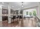 Open concept gourmet kitchen with stainless appliances, granite countertops and bar seating looking into the sunroom at 3304 Rockland Ridge Dr, Cary, NC 27519