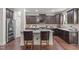 Modern kitchen with granite countertops, stainless steel appliances, and dark wood cabinetry at 3304 Rockland Ridge Dr, Cary, NC 27519