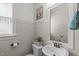 Charming powder room with classic fixtures, white paneling, and a decorative mirror at 3304 Rockland Ridge Dr, Cary, NC 27519