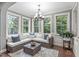 Bright sunroom filled with natural light, wicker furniture, and views of the lush green landscape at 3304 Rockland Ridge Dr, Cary, NC 27519