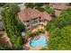 Aerial view of this home and pool with a hot tub, patio furniture, and natural landscaping at 3601 Nightfall Ct, Raleigh, NC 27607