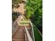 This backyard offers tiered outdoor spaces to enjoy the natural landscape at 3601 Nightfall Ct, Raleigh, NC 27607