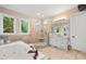 Spa-like bathroom with a soaking tub, glass-enclosed shower, and natural light at 3601 Nightfall Ct, Raleigh, NC 27607