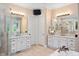 Bright bathroom featuring dual vanities, granite countertops, mirrors, and tiled floors at 3601 Nightfall Ct, Raleigh, NC 27607