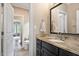 Bathroom featuring a vanity, granite countertop, and a toilet and doorway to bedroom at 3601 Nightfall Ct, Raleigh, NC 27607