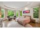 This light filled bedroom features a bay window, hardwood floors, and an ensuite bathroom at 3601 Nightfall Ct, Raleigh, NC 27607