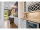 A butler's pantry featuring a wine rack, granite countertop, and beverage cooler enhances this elegant home at 3601 Nightfall Ct, Raleigh, NC 27607