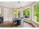 Chandelier-lit dining area with large windows, porch access, and stylish table and chairs at 3601 Nightfall Ct, Raleigh, NC 27607