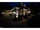 Exterior view of a stunning house with garage and beautiful outdoor lighting at dusk at 3601 Nightfall Ct, Raleigh, NC 27607