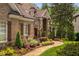 Charming home exterior featuring brick, stone accents, shutters, professional landscaping, and a stone walkway at 3601 Nightfall Ct, Raleigh, NC 27607