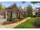 Charming home exterior with brick, stone, walkway, manicured landscaping, and lawn at 3601 Nightfall Ct, Raleigh, NC 27607