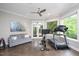 Bright home gym featuring exercise equipment, ceiling fan, and view of the backyard at 3601 Nightfall Ct, Raleigh, NC 27607