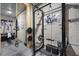 Home gym in unfinished basement, featuring squat rack, weights, and workout equipment at 3601 Nightfall Ct, Raleigh, NC 27607