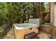 Outdoor hot tub nestled amongst mature landscaping with stone surround, providing a secluded and relaxing space at 3601 Nightfall Ct, Raleigh, NC 27607
