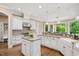 This kitchen has custom cabinets, granite countertops, a gas range, and windows providing natural light at 3601 Nightfall Ct, Raleigh, NC 27607