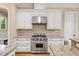 This kitchen is equipped with custom cabinets, granite countertops, stainless steel appliances, and a gas range at 3601 Nightfall Ct, Raleigh, NC 27607