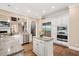 A kitchen featuring a center island, stainless steel appliances, and custom white cabinets makes a statement at 3601 Nightfall Ct, Raleigh, NC 27607