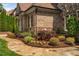 Charming landscaping details accent this home's exterior with thriving plants and a stone path at 3601 Nightfall Ct, Raleigh, NC 27607