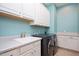 Well-equipped laundry room with ample storage cabinets and modern washer and dryer at 3601 Nightfall Ct, Raleigh, NC 27607