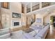 Bright living room features fireplace, built-ins, staircase, hardwood floors, and comfortable seating at 3601 Nightfall Ct, Raleigh, NC 27607