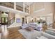 Open-concept living area with tall ceilings, hardwood floors, comfortable seating, and adjoining kitchen at 3601 Nightfall Ct, Raleigh, NC 27607