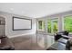 Spacious living room featuring a media center, natural light, and access to the outdoors at 3601 Nightfall Ct, Raleigh, NC 27607