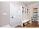 Convenient mudroom with built-in storage, bench, and easy access to powder room at 3601 Nightfall Ct, Raleigh, NC 27607