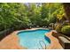 Enjoy the backyard pool, slide, lounge chairs and surrounding mature landscaping, a perfect outdoor oasis at 3601 Nightfall Ct, Raleigh, NC 27607
