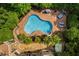 Stunning backyard pool and patio with ample lounge seating and beautiful natural landscaping at 3601 Nightfall Ct, Raleigh, NC 27607