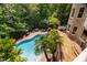 Beautiful home featuring a spacious outdoor pool and hot tub surrounded by mature trees at 3601 Nightfall Ct, Raleigh, NC 27607