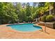 Enjoy the backyard pool, slide, lounge chairs and surrounding mature landscaping, a perfect outdoor oasis at 3601 Nightfall Ct, Raleigh, NC 27607