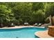 Enjoy the backyard pool, slide, lounge chairs and surrounding mature landscaping, a perfect outdoor oasis at 3601 Nightfall Ct, Raleigh, NC 27607