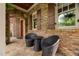 Brick porch with chairs and table, featuring stone flooring and archway entry at 3601 Nightfall Ct, Raleigh, NC 27607