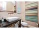 Elegant powder room with modern vessel sink, unique faucet, and artistic wall decor at 3601 Nightfall Ct, Raleigh, NC 27607