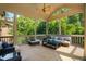 Relax on this screened in porch with views of the lush backyard, ceiling fan and wicker furniture at 3601 Nightfall Ct, Raleigh, NC 27607