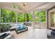 Inviting sunroom with vaulted ceilings, tiled floor and a scenic backyard view at 3601 Nightfall Ct, Raleigh, NC 27607