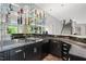 Sleek wet bar featuring black countertops, stainless steel appliances, and glass shelving at 3601 Nightfall Ct, Raleigh, NC 27607