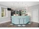Modern wet bar with a unique lit-up counter, bar stools, and ample shelving for storage at 3601 Nightfall Ct, Raleigh, NC 27607