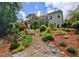 Expansive backyard with multilevel decks, manicured landscaping, and mature trees at 372 Farnleigh Dr, Chapel Hill, NC 27517