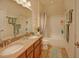 Well-lit bathroom featuring double sinks, granite countertops, and a bathtub with shower at 372 Farnleigh Dr, Chapel Hill, NC 27517