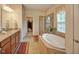 Luxurious bathroom with a soaking tub, a separate glass shower, and double vanity sinks at 372 Farnleigh Dr, Chapel Hill, NC 27517