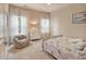 Cozy bedroom features a plush chair and nautical themed bedding with ample natural light at 372 Farnleigh Dr, Chapel Hill, NC 27517