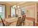 Bright dining area with a chandelier, spacious layout, and elegant windows and doorway at 372 Farnleigh Dr, Chapel Hill, NC 27517