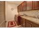 Functional laundry room equipped with a washing machine, dryer, sink, and ample cabinet space at 372 Farnleigh Dr, Chapel Hill, NC 27517