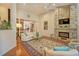 Spacious living room features a stone fireplace, hardwood floors, and a comfortable white sofa at 372 Farnleigh Dr, Chapel Hill, NC 27517