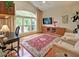 Comfortable living room with a large window, desk and TV, offering relaxation and entertainment at 372 Farnleigh Dr, Chapel Hill, NC 27517